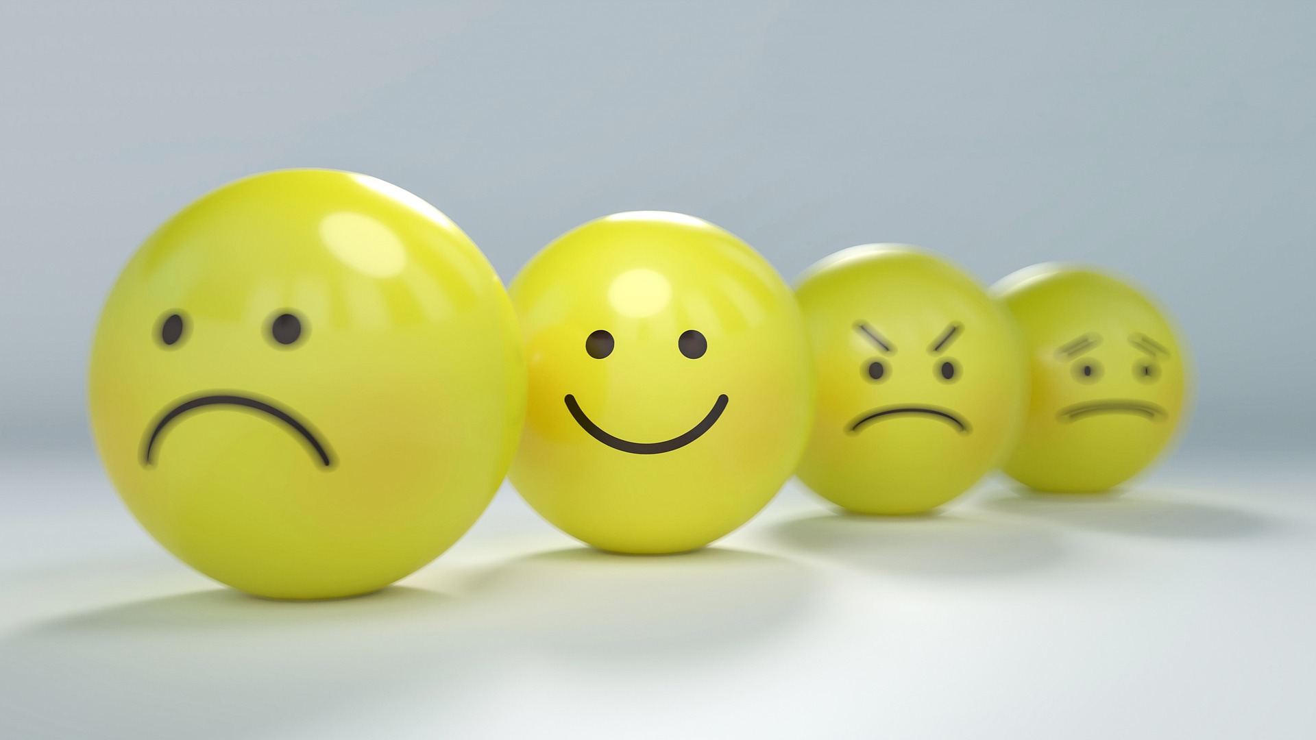 smiley faces showing range of happy and negative emotions