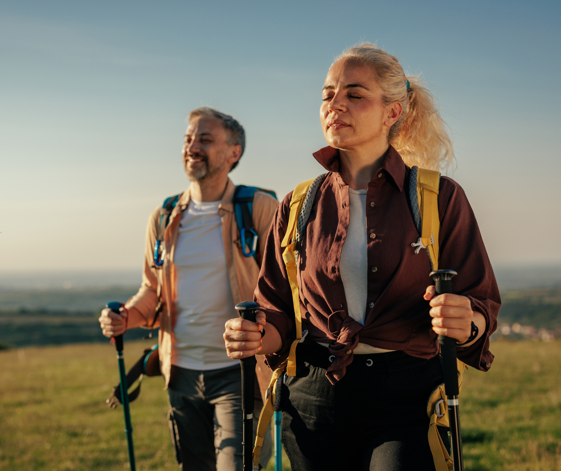 man and woman hiking at sunset